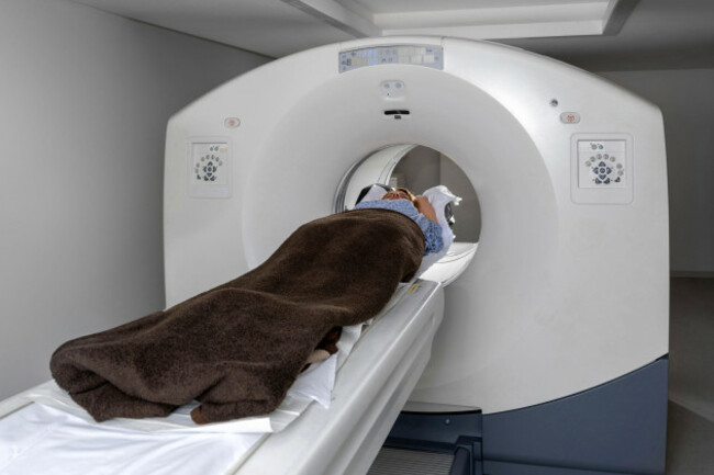 female-patient-lying-on-ct-mri-or-pet-scan-bed-moving-inside-the-machine-for-body-and-brain-imaging-high-tech-equipment-in-modern-nuclear-medicine