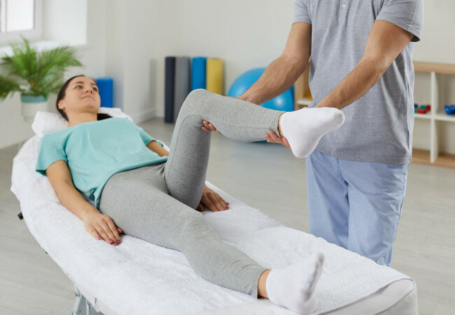 physiotherapist-help-female-patient-with-leg-recovery