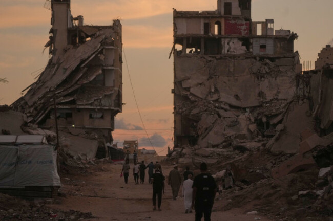 palestinians-walk-along-a-street-surrounded-by-buildings-destroyed-in-israeli-military-strikes-during-the-israel-hamas-war-in-gaza-city-tuesday-oct-6-2026-ap-photojehad-alshrafi
