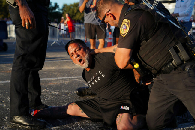 san-antonio-texas-usa-7th-oct-2026-law-enforcement-arrest-a-man-for-fighting-with-people-waiting-to-see-us-president-trump-during-a-midterm-election-campaign-rally-at-freeman-coliseum-trump-is-c