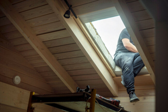 a-worker-maintaining-a-skylight-focus-in-the-foreground