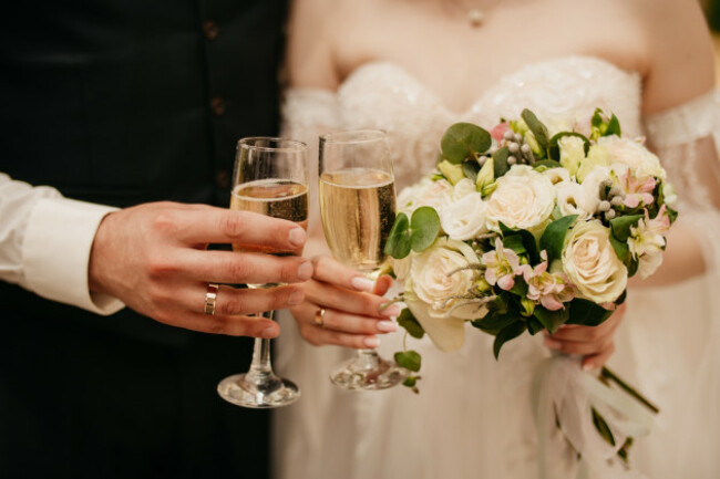 thebrideandgroomholdglassesofchampagneanda