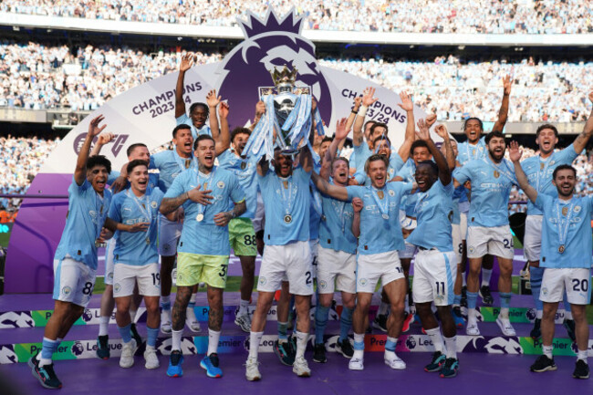 file-manchester-city-players-celebrate-with-the-premier-league-trophy-after-the-english-premier-league-soccer-match-between-manchester-city-and-west-ham-united-in-manchester-england-sunday-may-19