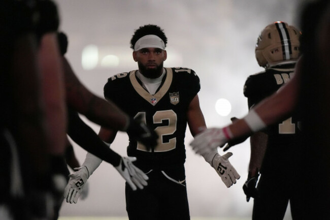 new-orleans-saints-wide-receiver-chris-olave-12-is-greeted-by-teammates-before-an-nfl-football-game-against-the-minnesota-vikings-in-new-orleans-sunday-oct-11-2026-ap-photogerald-herbert
