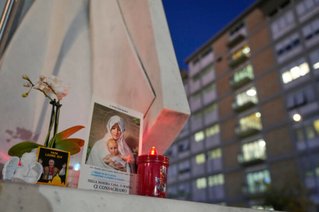 an-image-of-pope-leo-xiv-rests-at-the-base-of-a-statue-of-the-late-pope-john-paul-ii-outside-the-agostino-gemelli-polyclinic-where-leo-is-hospitalized-for-surgery-to-remove-a-lung-nodule-in-rome-tu