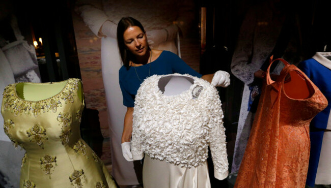 curator-caroline-de-guitaut-adjusts-the-white-silk-crepe-gown-featuring-2091-chiffon-shamrocks-that-was-worn-by-britains-queen-elizabeth-ii-for-the-historic-first-state-visit-to-ireland-in-2011-dur