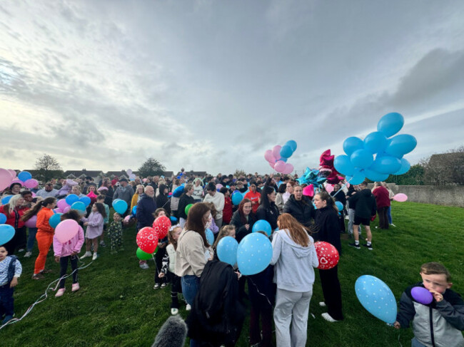 people-gather-ahead-of-a-balloon-release-ceremony-to-commemorate-the-lives-lost-in-a-house-fire-in-birchwood-waterford-multiple-properties-have-been-searched-as-part-of-a-continued-garda-investigat