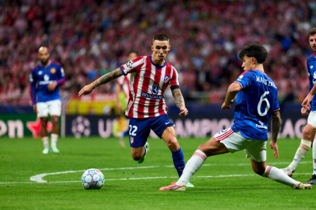 alejandro-grimaldo-of-atletico-de-madrid-battles-for-the-ball-with-lisandro-martinez-of-manchester-united-during-the-uefa-champions-league-match-between-atletico-de-madrid-and-manchester-united-at-riy