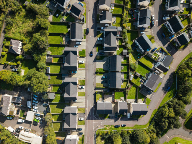 aerial-view-of-a-residential-neighborhood-with-modern-houses-dark-roofs-green-lawns-paved-driveways-and-winding-streets-in-lisburn-northern-irela