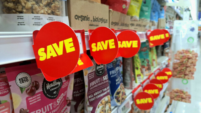 toronto-on-canada-july-30-2026-red-save-tags-with-yellow-text-are-attached-to-store-shelves-displaying-grocery-products