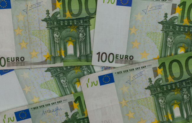 a-detailed-top-down-view-of-several-green-100-euro-bills-overlapping-across-the-frame