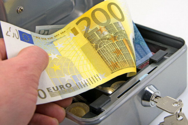 hand-reaches-into-a-cash-box-with-euro-bills