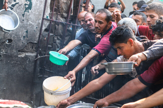 palestine-24th-oct-2026-palestinians-including-children-carrying-bowls-and-cooking-pots-gather-near-a-charity-kitchen-to-receive-hot-meals-in-jabalia-refugee-camp-northern-gaza-strip-october-24