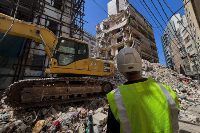 workers-remove-the-rubble-as-rescuers-keep-searching-for-the-bodies-of-a-missing-woman-and-girl-at-a-destroyed-building-that-was-hit-on-wednesday-april-8-in-an-israeli-airstrike-in-beirut-lebanon