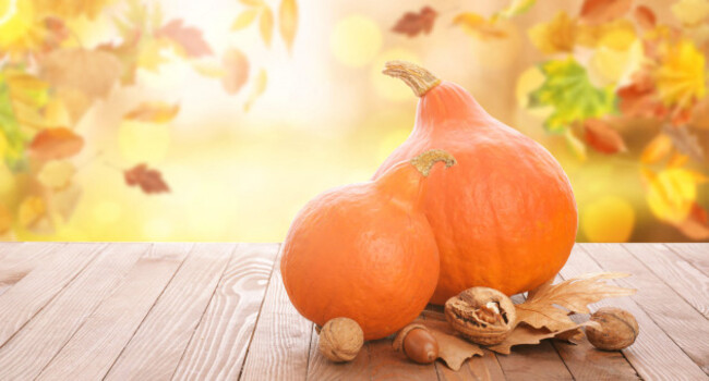 fresh-pumpkins-nuts-and-autumn-leaves-on-wooden-table-outdoors