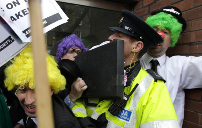 gardai-scuffle-with-sinn-fein-activists-mimicking-imf-officials-as-they-picket-the-european-union-headquarters-in-dublin-as-ireland-marks-the-one-year-anniversary-of-the-euimf-bailout-loan